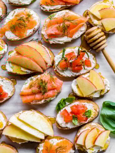Easy whipped feta crostini with tomato, salmon, and apple toppings