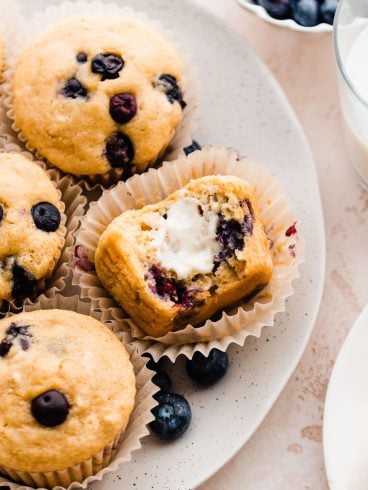 Buttermilk Blueberry Muffins with butter on a plate