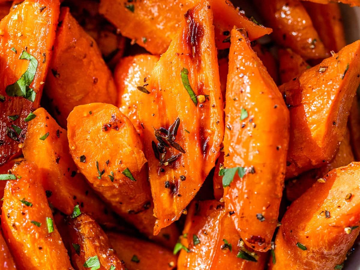 a white bowl with herb honey roasted carrots