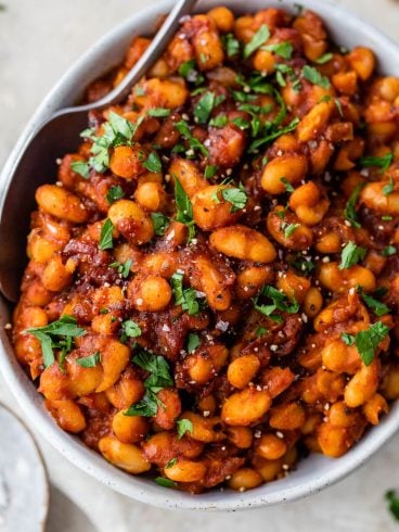 Healthy Baked Beans easy in a bowl with parsley and spoon