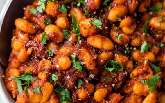Healthy Baked Beans easy in a bowl with parsley and spoon