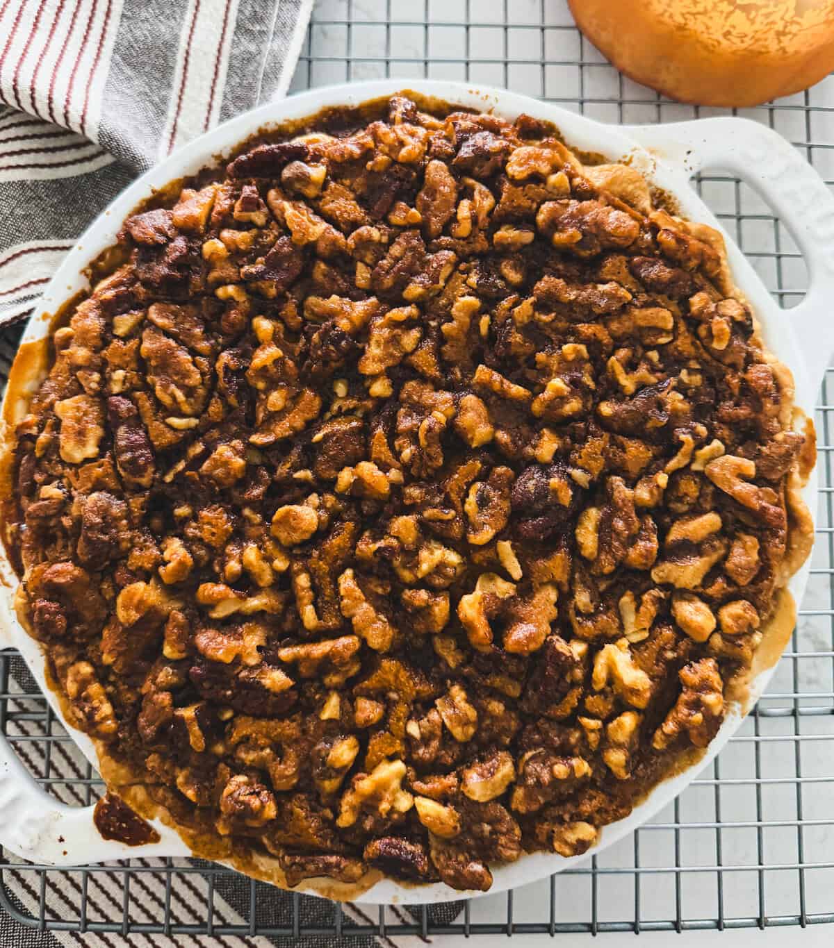 pumpkin pecan pie on a cooling rack
