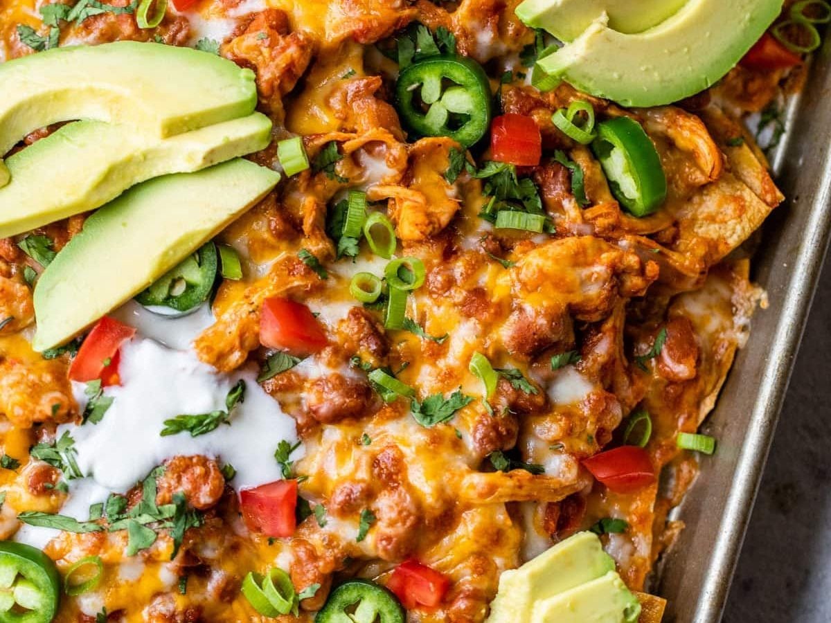 platter of healthy chicken nachos with shredded chicken and queso