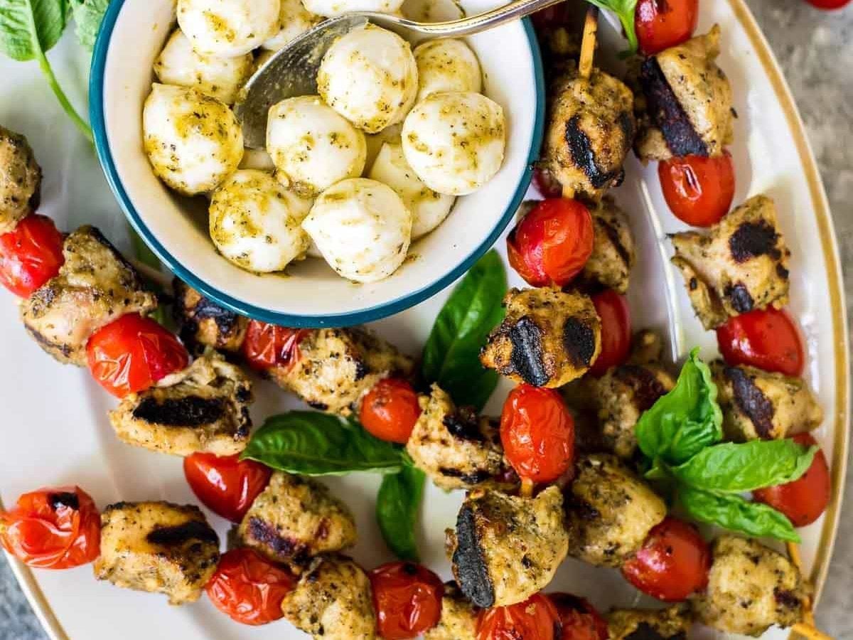 These Grilled Pesto Chicken Kebabs are the perfect summer dish! EASY recipe with ONLY THREE INGREDIENTS — Serve as appetizer at your next backyard bash, or have them for dinner any night of the week. Healthy and delicious! @wellplated