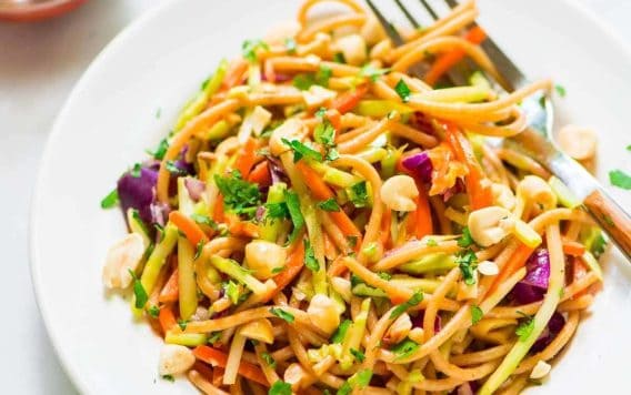 Asian Noodle Salad with Peanut Dressing. This is the BEST cold pasta salad recipe! Whole wheat pasta mixed with crunchy veggies in a sweet and spicy peanut sauce. Packed with flavor, healthy, and filling too! @wellplated