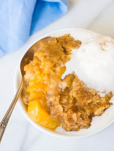 Crock Pot Peach Cobbler. This easy dessert is made entirely in your slow cooker! Juicy peaches, a sweet, buttery topping, and it couldn’t be simpler. Just dump the ingredients into your crockpot and walk away! @wellplated