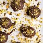 Dark Chocolate Paleo Pistachio Truffles. A healthy raw vegan dessert that everyone can enjoy! This no bake dessert is perfect for homemade Christmas gifts, cookie plates, or anytime you want a treat at the holidays! {gluten free, clean eating, and dairy free} Recipe at wellplated.com | @wellplated