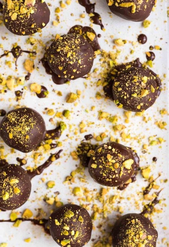 Dark Chocolate Paleo Pistachio Truffles. A healthy raw vegan dessert that everyone can enjoy! This no bake dessert is perfect for homemade Christmas gifts, cookie plates, or anytime you want a treat at the holidays! {gluten free, clean eating, and dairy free} Recipe at wellplated.com | @wellplated