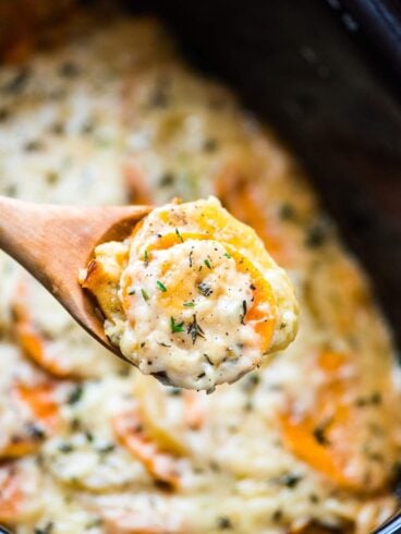close up photo of a spoon full of crock pot scalloped potatoes