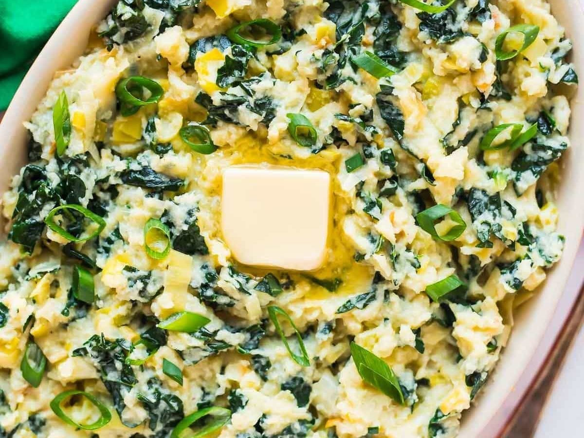 Paleo Colcannon. A healthy low carb version of traditional Irish colcannon that uses mashed cauliflower instead of potatoes. The green kale and onions make it a perfect recipe for St. Patrick’s Day! vegan, gluten free Recipe at wellplated.com | @wellplated