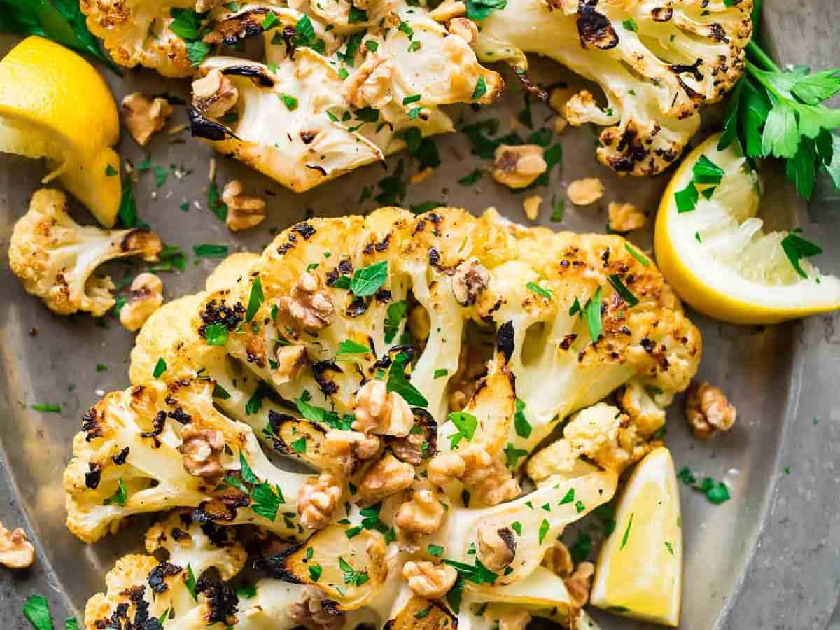 Grilled Cauliflower Steaks with honey, lemon, and toasted walnuts. Meaty, caramelized, and satisfying! Easy, low carb recipe that’s perfect for a simple side or light dinner. {can be made vegan; gluten free} Recipe at wellplated.com | @wellplated