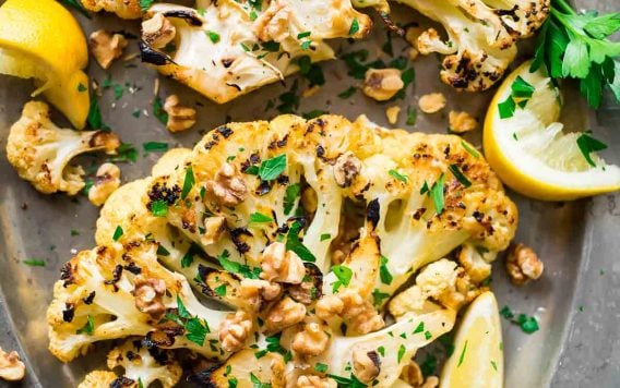 Grilled Cauliflower Steaks with honey, lemon, and toasted walnuts. Meaty, caramelized, and satisfying! Easy, low carb recipe that’s perfect for a simple side or light dinner. {can be made vegan; gluten free} Recipe at wellplated.com | @wellplated