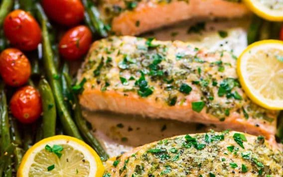 Easy Sheet Pan Baked Garlic Salmon with Lemon Butter and Veggies. Healthy, ready in 30 minutes, and everything cooks on ONE pan for easy clean up! Try it with green beans and asparagus, roasted tomatoes, or any of your favorite vegetables. {gluten free} Recipe at wellplated.com | @wellplated