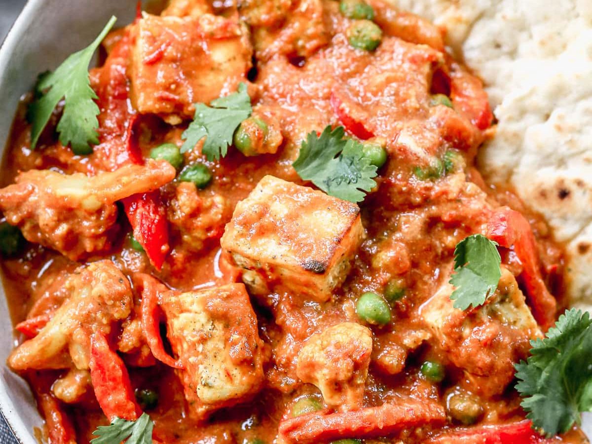 a bowl of Paneer masala restaurant style with greek yogurt and bell peppers