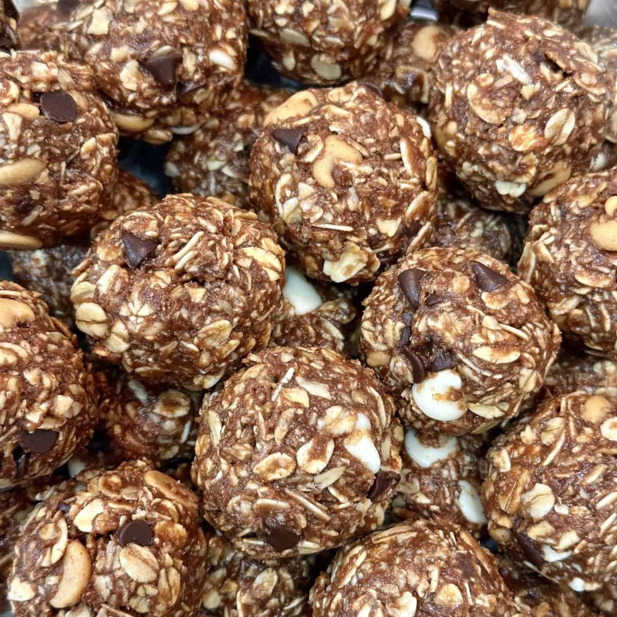 Close-up of homemade oat and chocolate energy bites with visible oats, chocolate chips, and nuts.