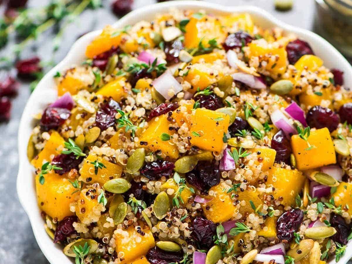 Maple Butternut Squash Quinoa Salad with Cranberries. A healthy, gluten free recipe filled with fall flavors. Easy, filling and perfect for make ahead lunches and dinners! Recipe at wellplated.com | @wellplated