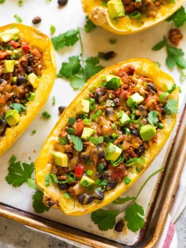 Healthy Taco Spaghetti Squash Boats with Cheese, Ground Turkey, and Black Beans. Easy, filling, and low carb! Great for busy families. Everyone loves this recipe! {gluten free}. Recipe at wellplated.com