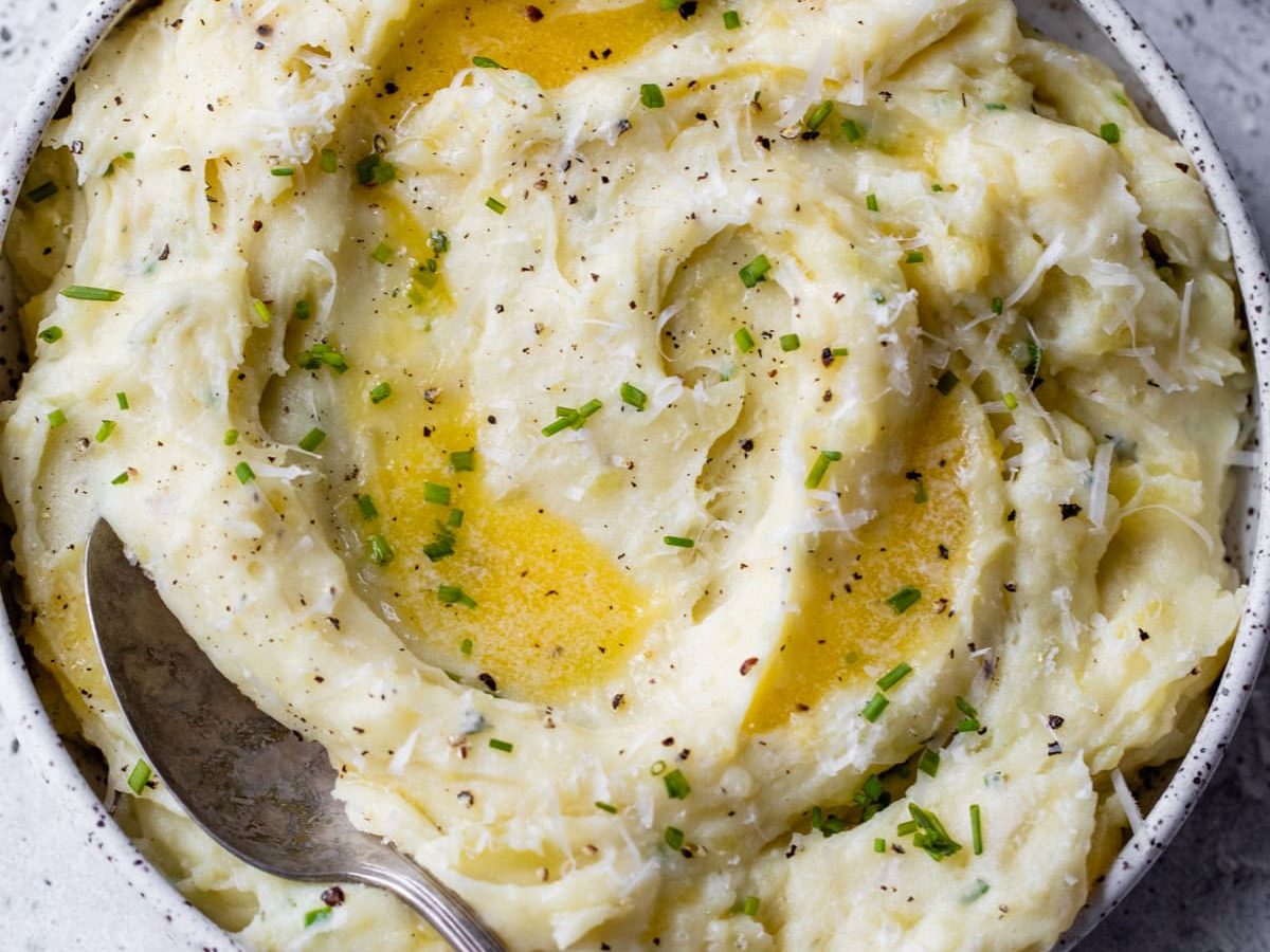 buttery mashed potatoes made in instant pot with herbs, cheese, butter, and greek yogurt
