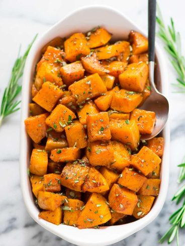 Maple Cinnamon Roasted Butternut Squash with Rosemary. Butternut squash cubes tossed with maple syrup and cinnamon, then roasted until sweet, caramelized, and absolutely delicious! An easy, healthy side dish recipe for Thanksgiving, Christmas, or even a simple weeknight!