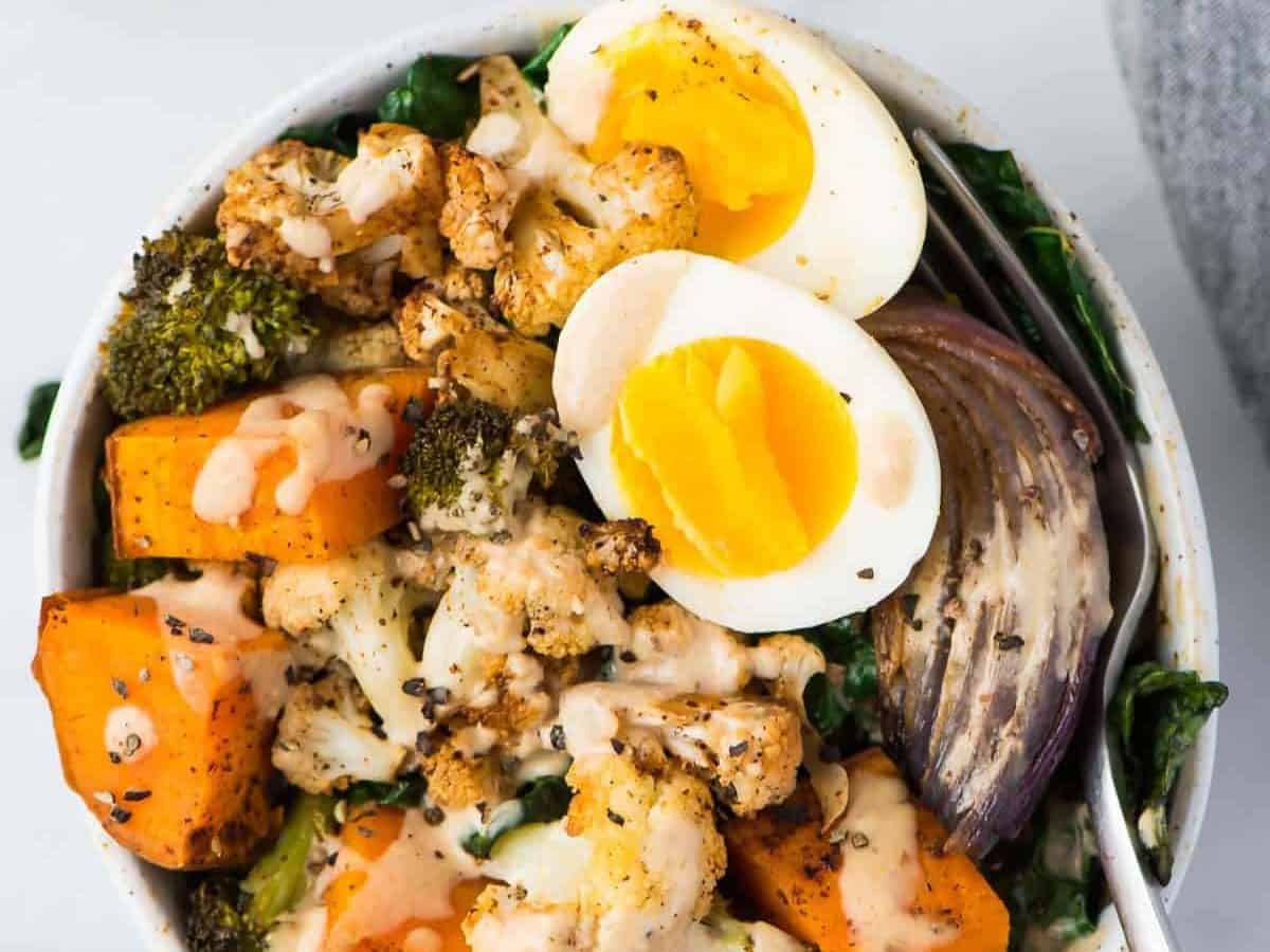 Easy and healthy Whole30 Vegetarian Power Bowl. Low carb, packed with roasted veggies, with a creamy and delicious Whole30 dressing. Top with a soft boiled egg for a filling, high protein vegetarian meal! Dairy free, gluten free, grain free, and Paleo compliant.