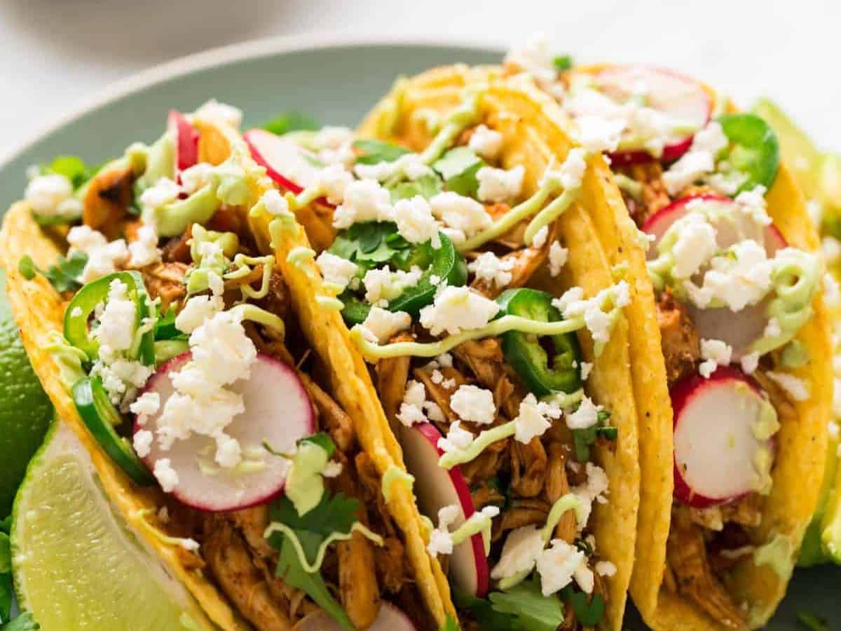 The BEST EVER Instant Pot Shredded Chicken Tacos! Easy, juicy pressure cooker Mexican chicken that's healthy and full of flavor. Use it for tacos, burritos, taco bowls, or mix with black beans and rice. #pressurecooker #instantpot #shreddedchicken #healthy