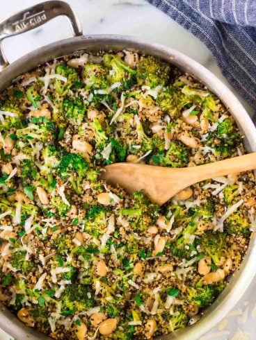 One Pan Cheesy Broccoli Quinoa Skillet with Parmesan and White Beans. An easy and filling vegetarian recipe that's great for quick dinners and healthy meal prep lunches.