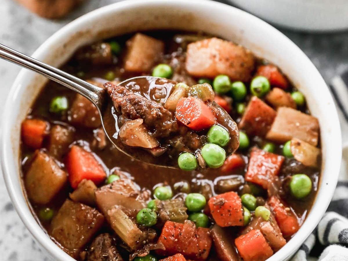 The BEST Crock Pot Beef Stew ever in a bowl with a spoon