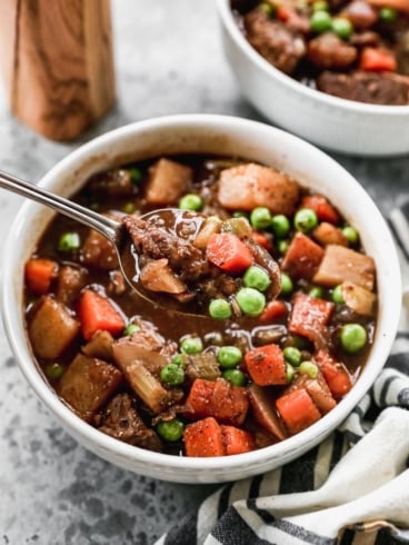 The BEST Crock Pot Beef Stew ever in a bowl with a spoon