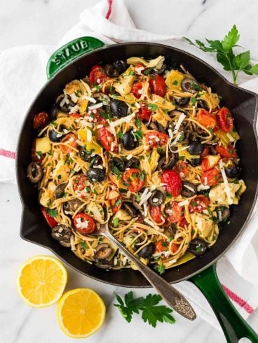 A skillet of Mediterranean pasta with olives and tomatoes