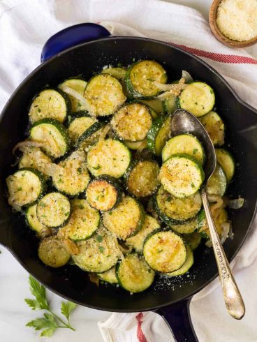 Easy Sauteed Zucchini with Onions and Parmesan. Golden, delicious zucchini and squash, cooked with butter, garlic, and your favorite seasonings. Healthy and simple, it's the perfect summer side dish!