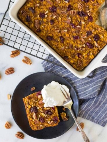 Healthy Pumpkin Baked Oatmeal with dried cranberries, maple syrup, and pecans. No sugar! Super filling and absolutely delicious! Perfect for fall mornings and on-the-go healthy snacks.