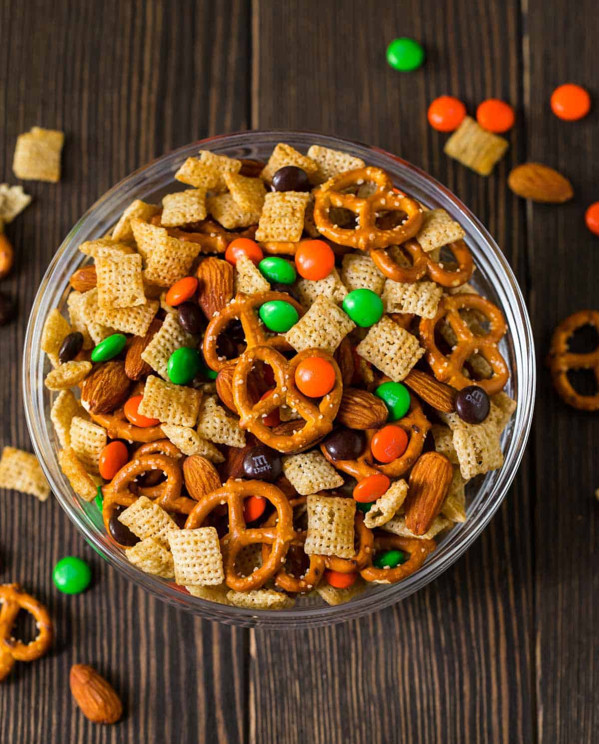 Chocolate Orange Party Mix. Sweet, salty, and perfect for Halloween! You can use halloween colored chocolates or swap out the colors for Christmas or your team's colors for game day. #chexmix #partymix #wellplatedrecipes