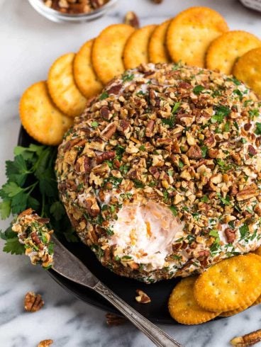 A sweet and savory Cream Cheese Ball with Cheddar, Strawberry Preserves, and Pecans. This easy twist on a classic cheese ball recipe is the BEST cheese ball youโll ever taste! A perfect appetizer for Thanksgiving, Christmas, and football games.