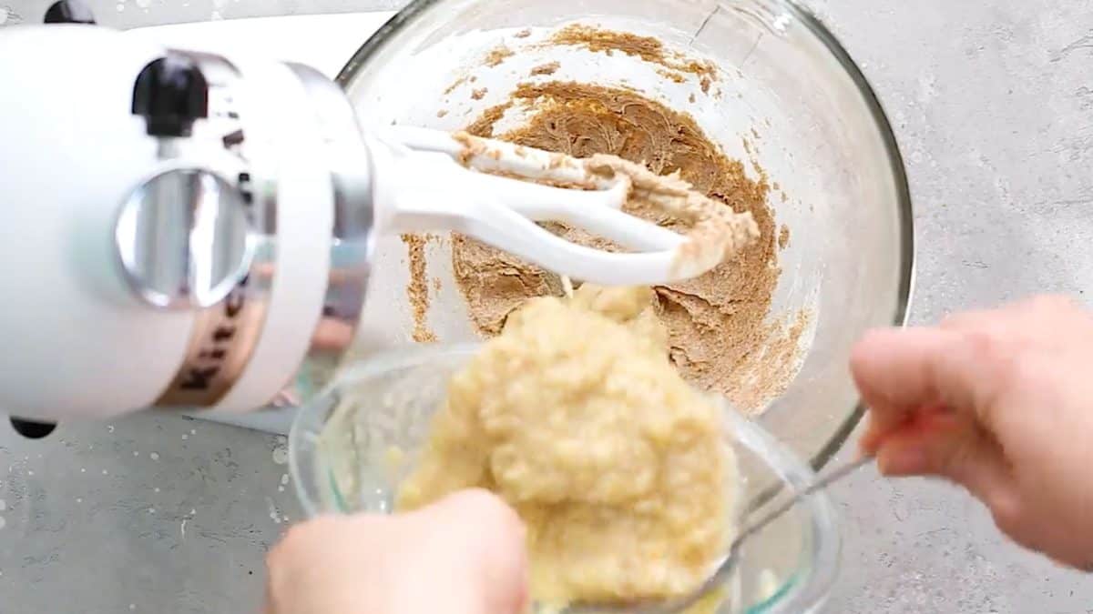 Pouring wet ingredients into stand mixer.