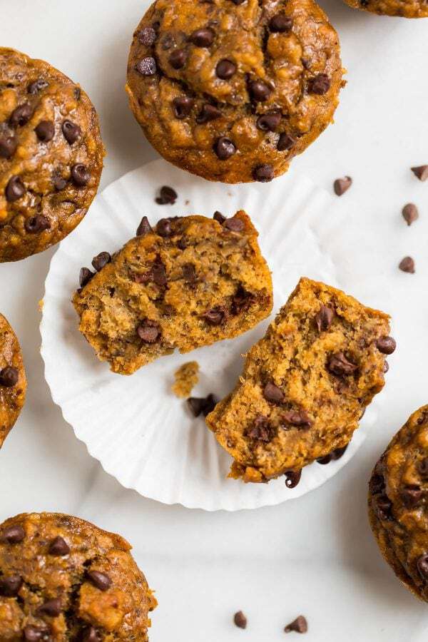 Moist healthy banana chocolate chip muffins with applesauce. Easy, vegan, and whole wheat, these simple muffins are perfect for healthy breakfasts! Clean eating and kid friendly.
