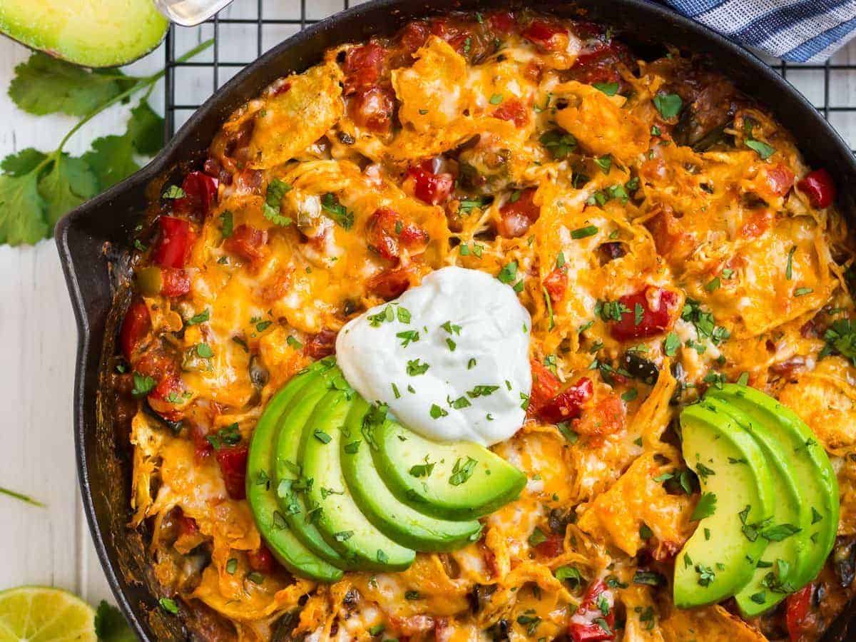 A skillet of king ranch chicken with avocado