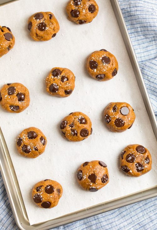 Raw cookie dough balls on a baking sheet