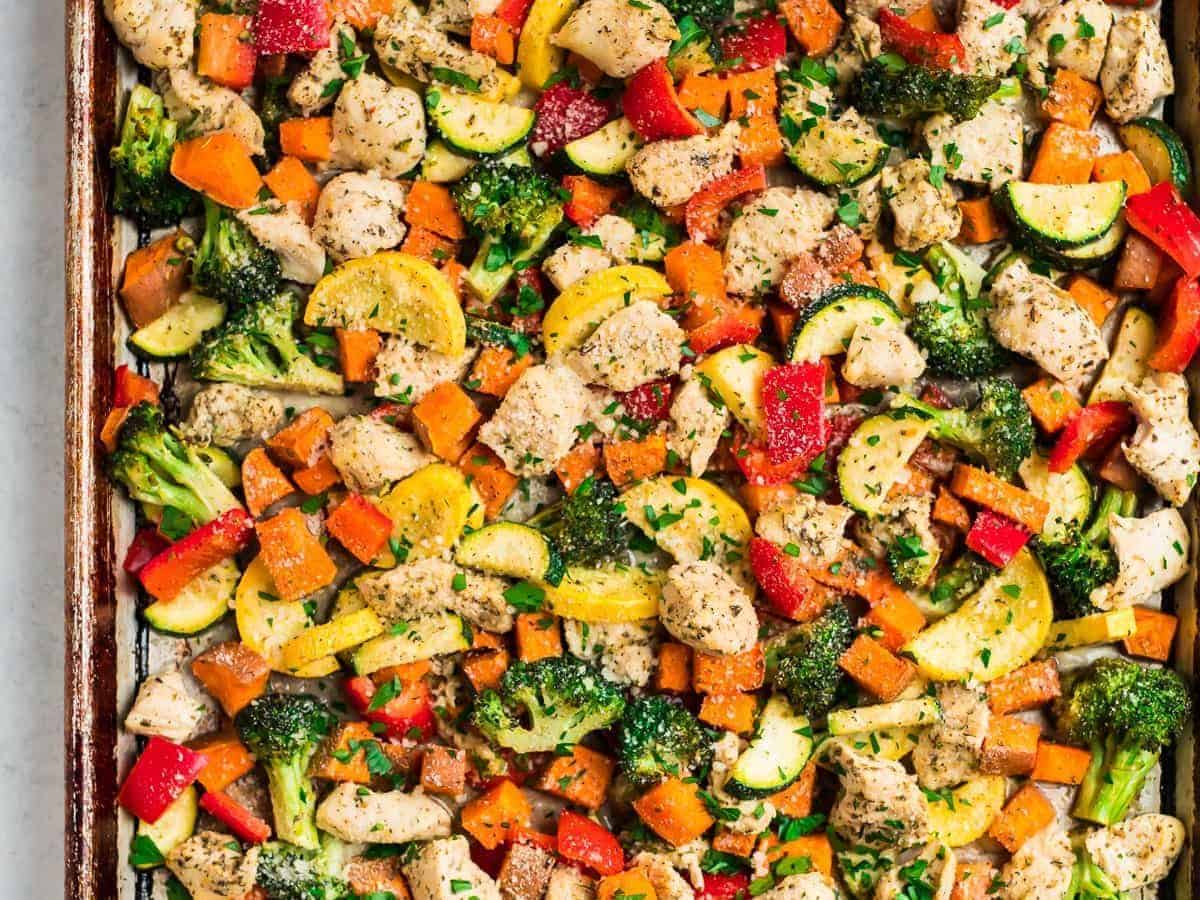 A sheet pan with chicken and rainbow vegetables