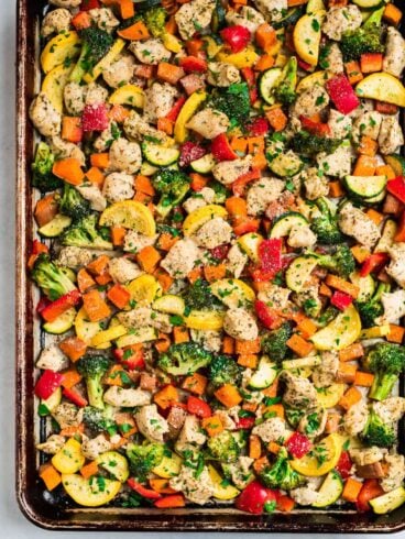 A sheet pan with chicken and rainbow vegetables