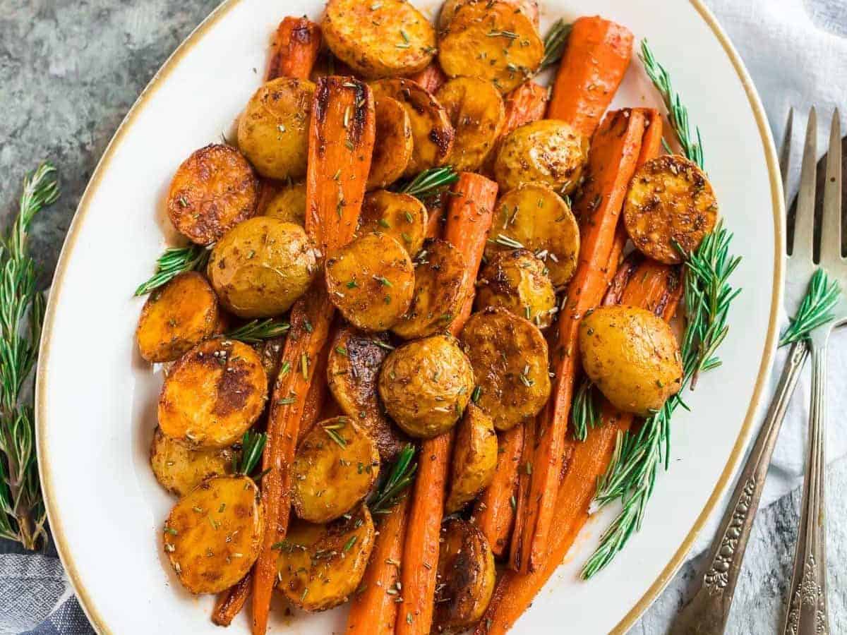 Perfect Roasted Potatoes and Carrots with Rosemary on a white plate