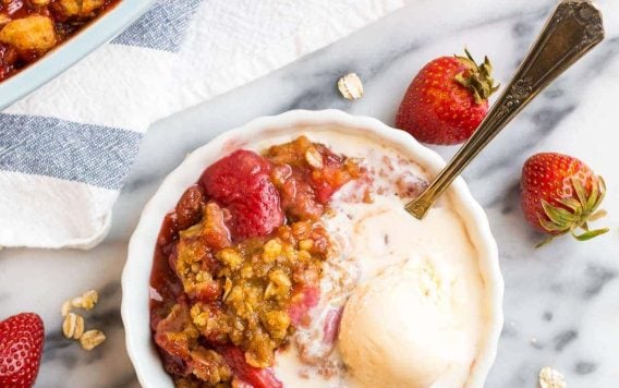 Easy Strawberry Crisp with healthy Oat topping and vanilla ice cream.