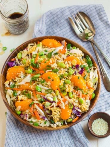 Ramen salad in a wooden bowl with Mandarin oranges on top