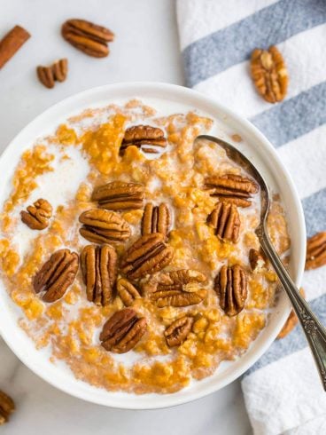 A bowl of easy healthy pumpkin oatmeal topped with pecans