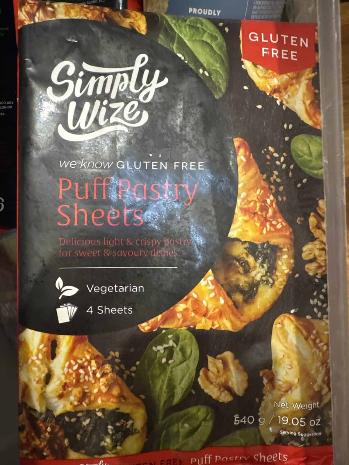 Package of Simply Wize gluten free puff pastry sheets, showing pastries with spinach and a vegetarian label.