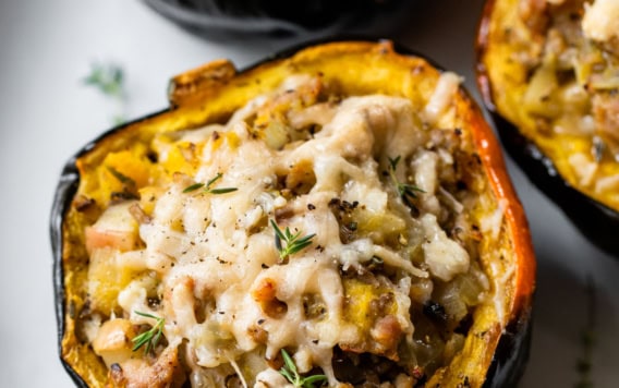 stuffed acorn squash with sausage and cheese on a plate