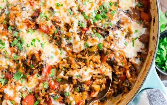 Stuffed Pepper Casserole with cheese, meat, bell peppers, and tomatoes in a skillet with cheese on top.
