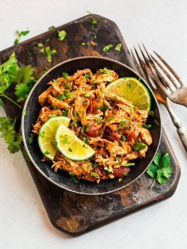 A bowl filled with shredded Mexican chicken made in the slow cooker