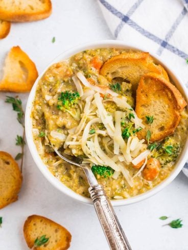 A bowl of broccoli cauliflower soup with bread