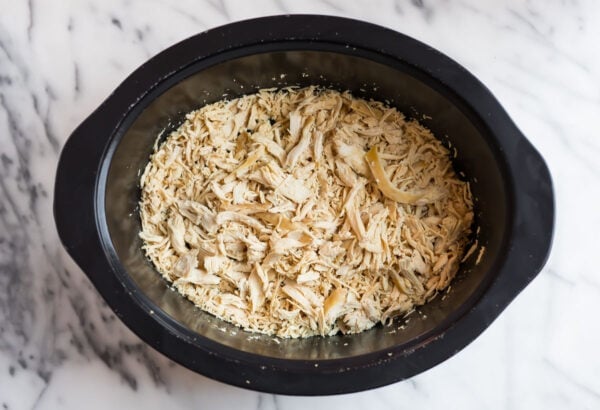a crock pot with shredded chicken