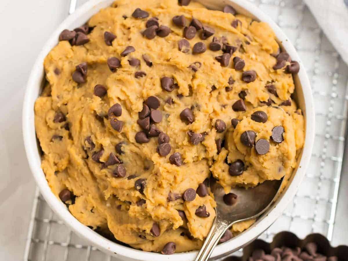 A white bowl with healthy chickpea cookie dough with chocolate chips